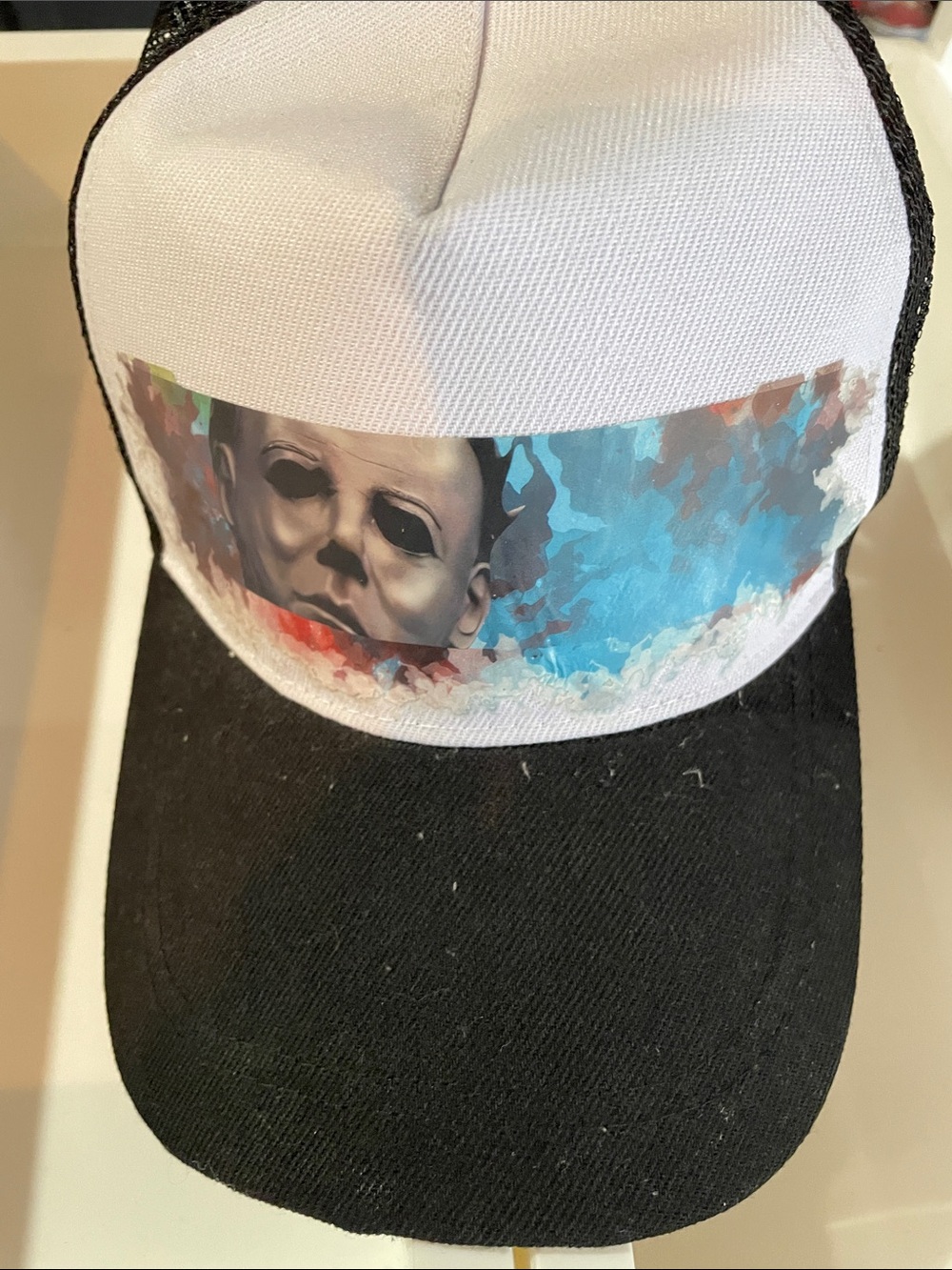 White & Black Trucker Cap with Abstract Mask Graphic